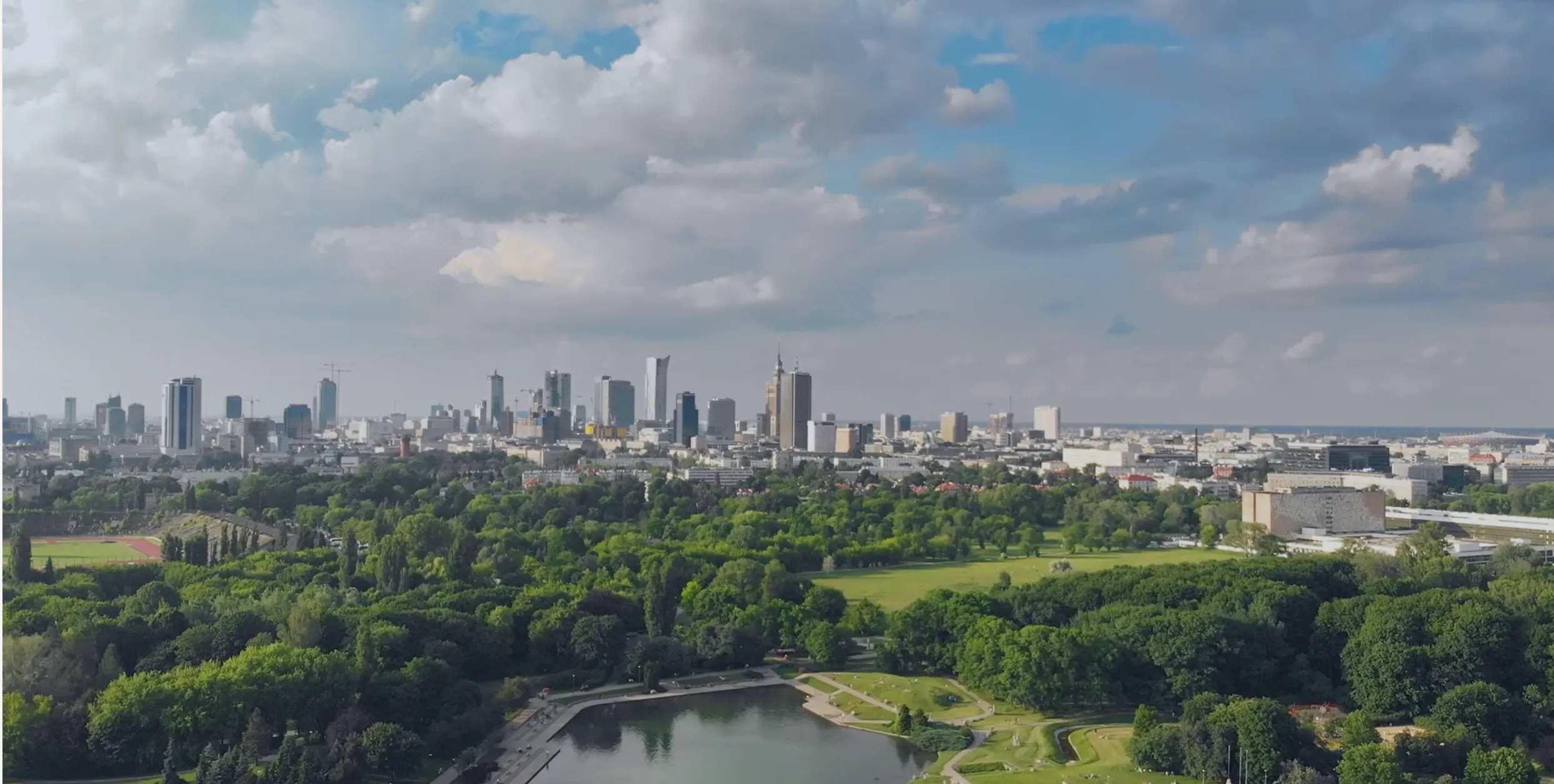 A European city seen from the air, with a large park in the foreground